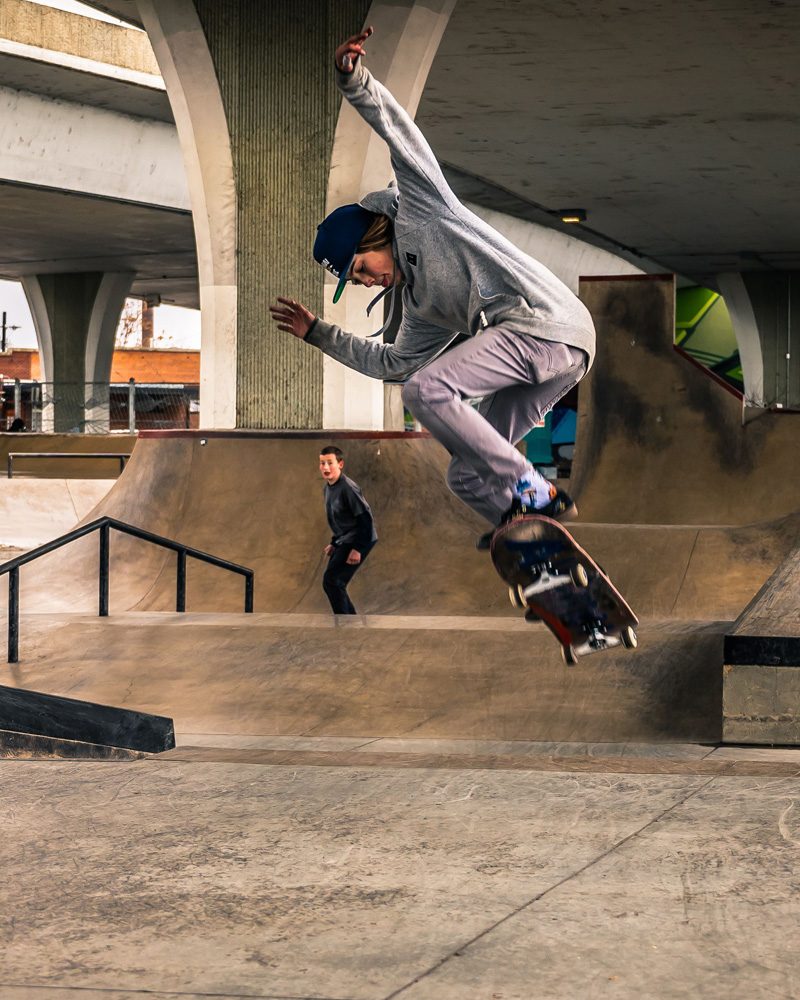 Skateboarder mid-air at a skatepark